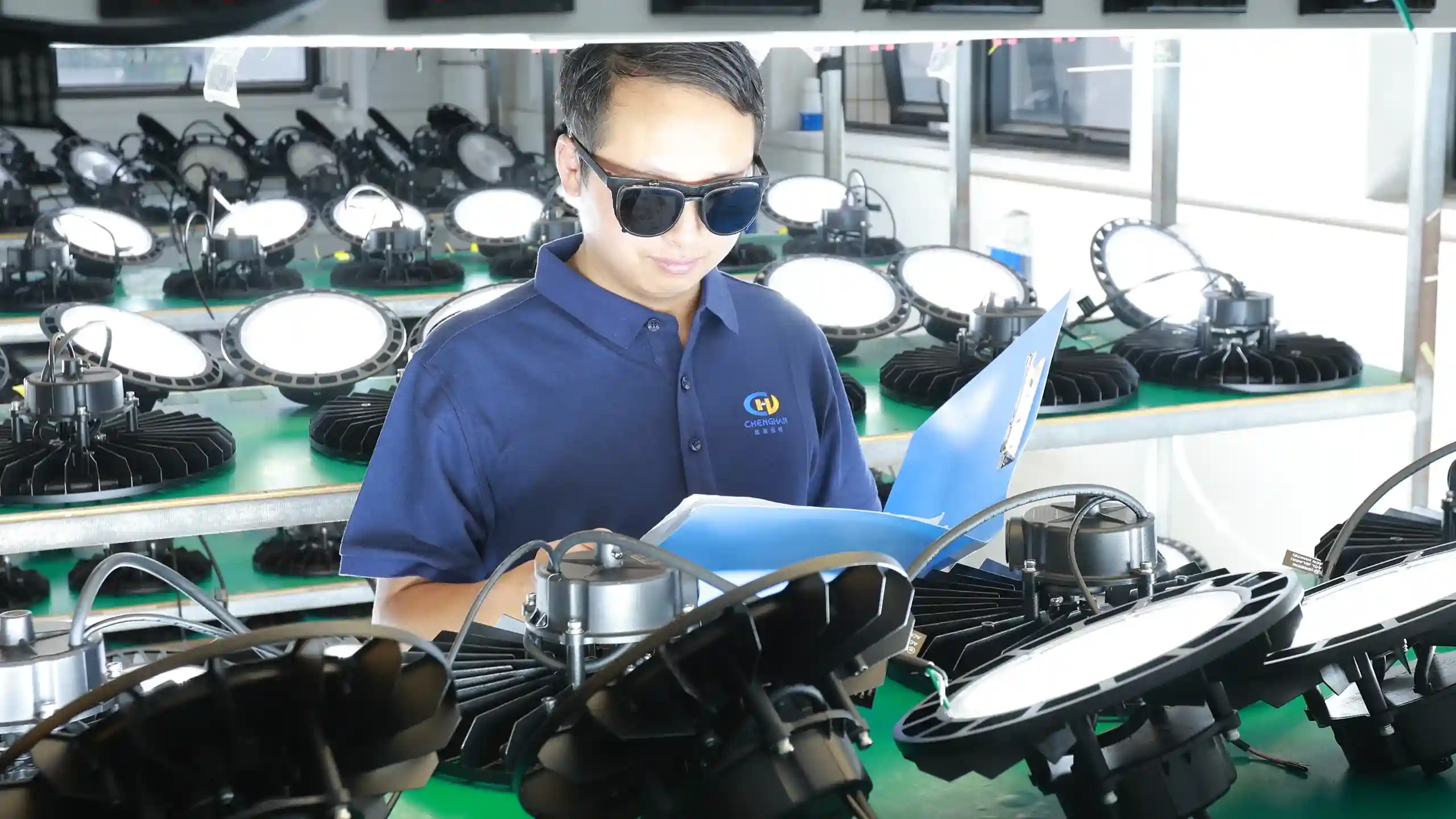Inspectors examine each light one by one on the aging test rack.