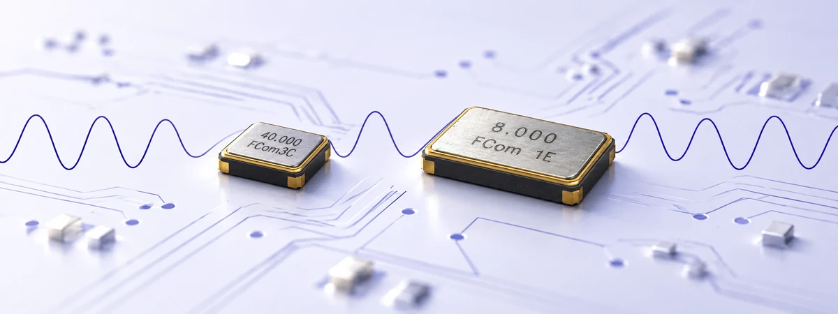 FCom quartz timing components marked 40.000 and 8.000 on a circuit board with a signal waveform
