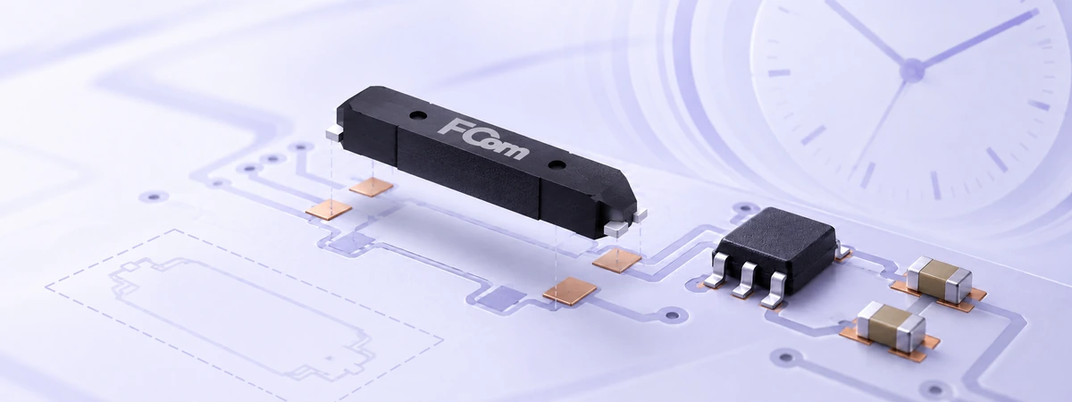 FCom FCT-6M crystal above a PCB footprint beside an RTC chip and load capacitors.